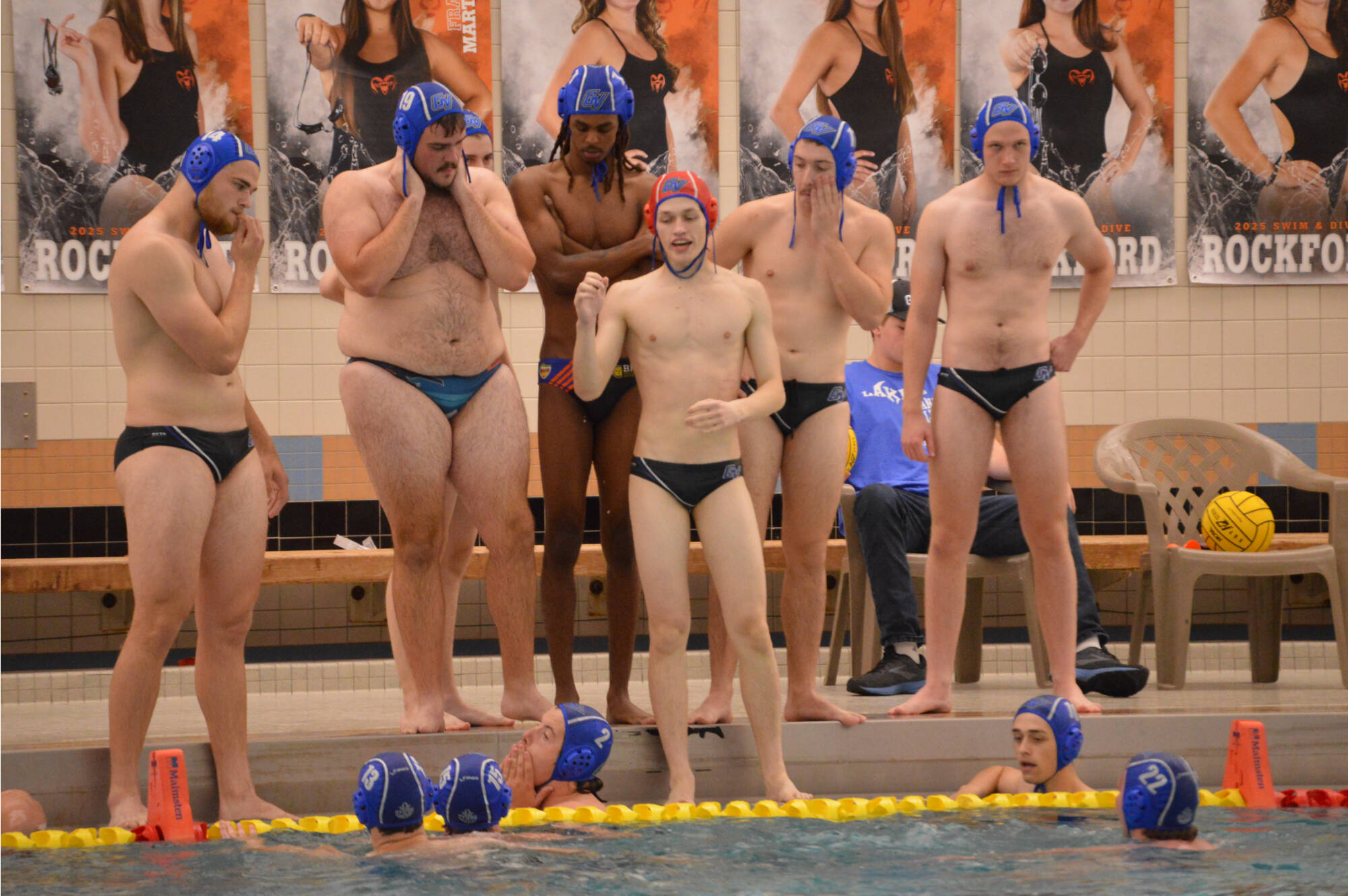 Water polo team discussing strategy during a timeout.